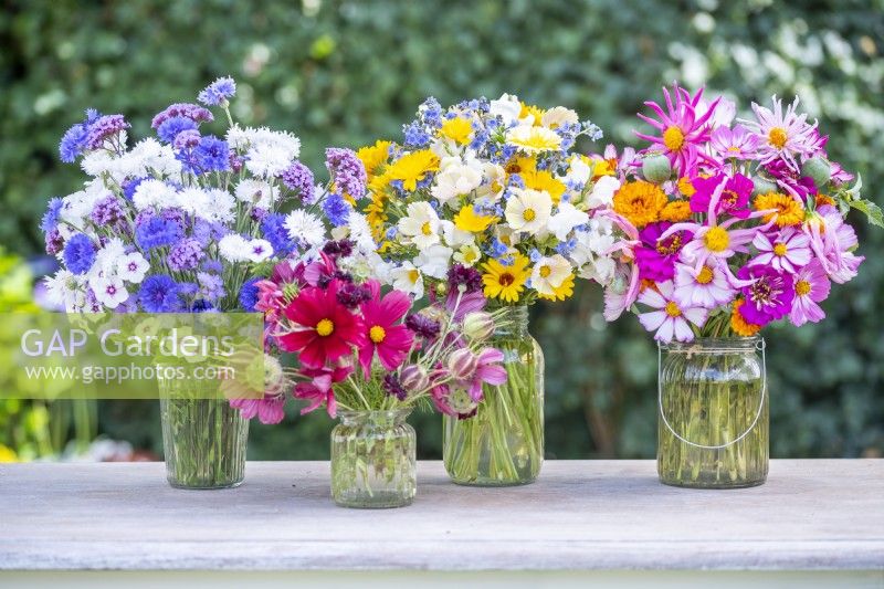 Four different bouquets on a wooden table