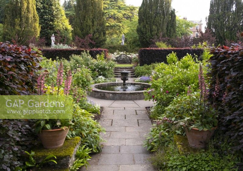 A view of the urn shaped fountain and circular pond in the rose garden at Newby Hall Gardens.