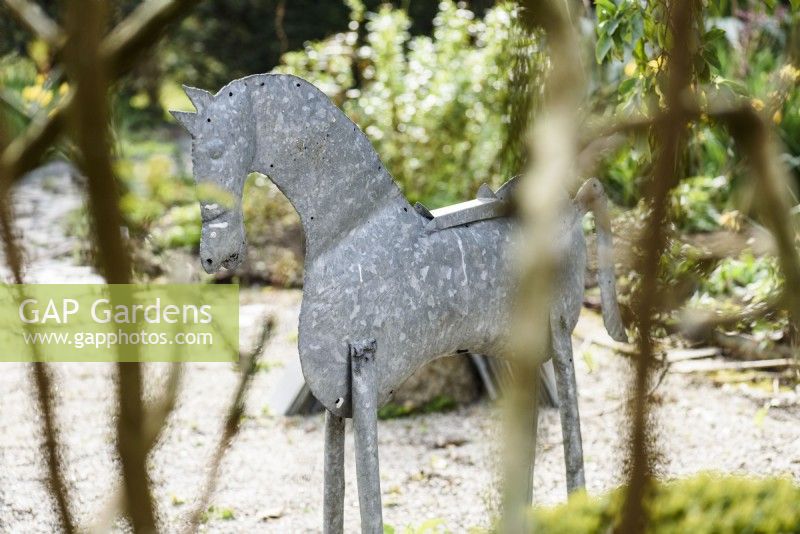 Tin horse in a spring garden