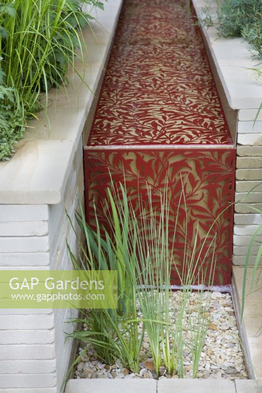 Morris  and  Co. Garden. Designer: Ruth Willmott. RHS Chelsea Flower Show 2022. Gold Medal. Water rill with William Morris 'Willow Boughs' laser cut design in metal.