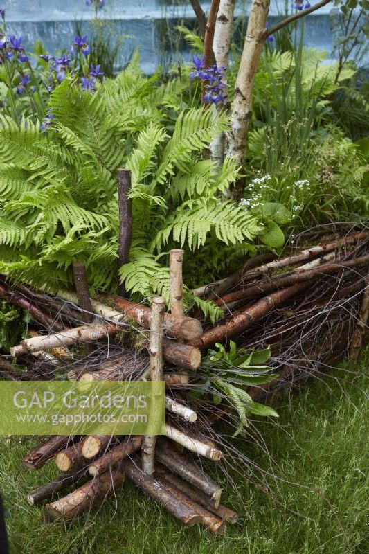 Natural coppiced wooden fencing with twigs for insects to live in.