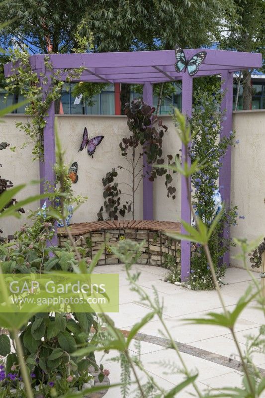 Purple wooden pergola in the Metamorphosis garden at BBC Gardener's World Live 2022