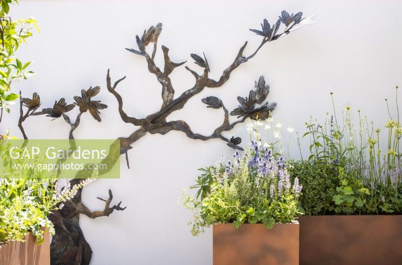 Wall sculpture by Emma Rodgers, Corten steel planters with herbaceous planting  - John King Brain Tumour Foundation Garden, RHS Hampton Court Palace Garden Festival 2022