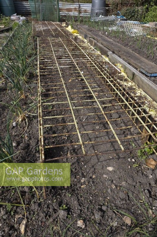 Recycled metal racks used for bird protection on allotment, vegetable plot