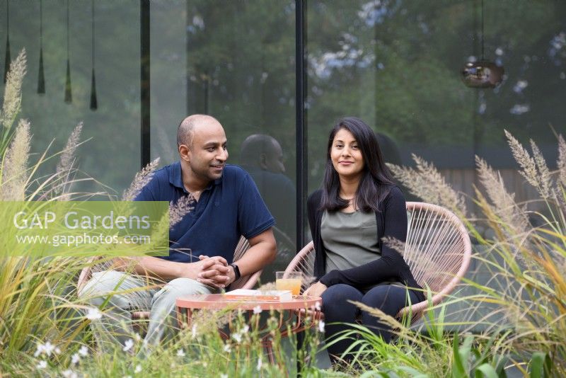 The designer and owner Vishal and his wife Meera relaxing in their garden. 