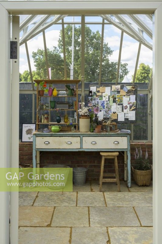 Inside of Alitex Greenhouse in Wood Sage, furnished with  pre-loved items from Lamb  and  Newt and surrounded by paving  by Westminster Stone