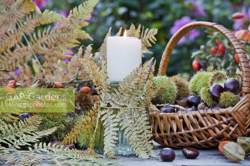 Decorative candle holder with ferns.