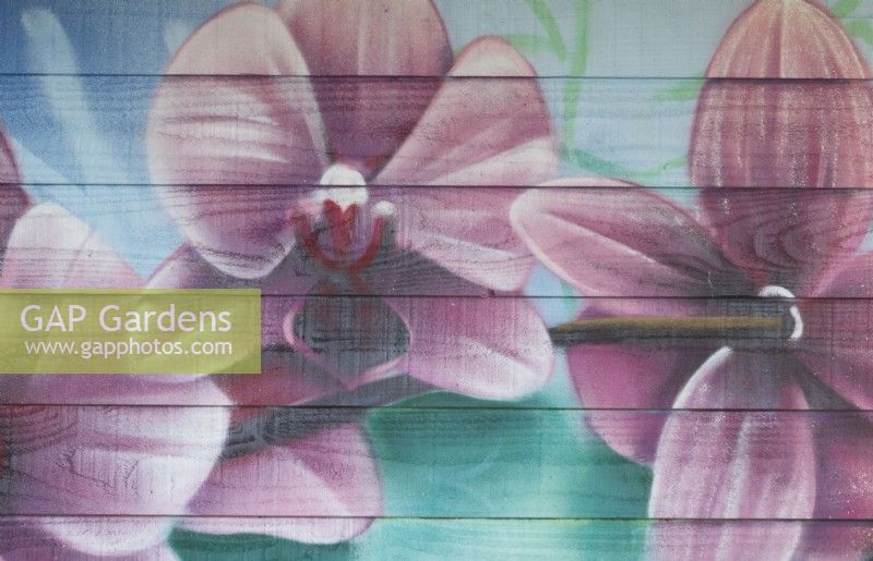 Painted spring flowers on wooden wall.