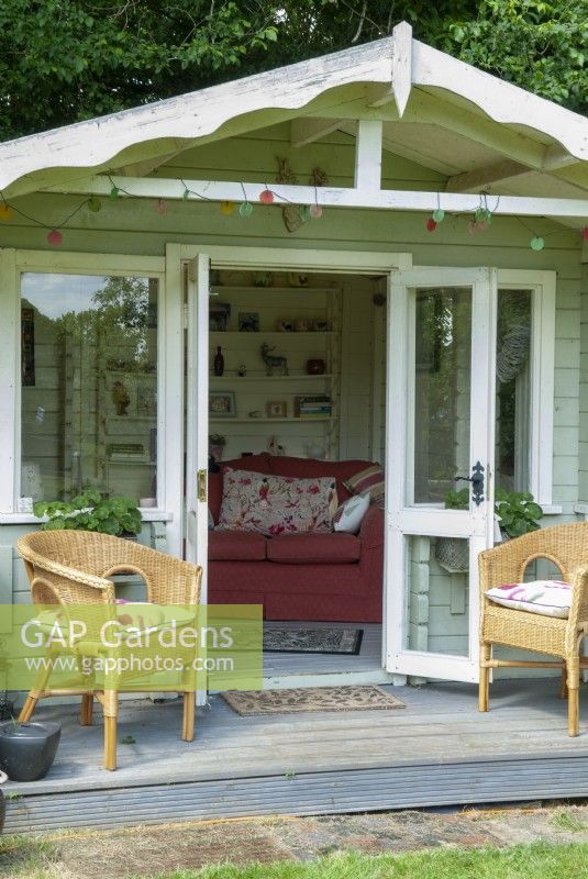 Summerhouse with veranda, two cane chairs and furniture and shelving within - Open Gardens Day, Old Newton, Suffolk