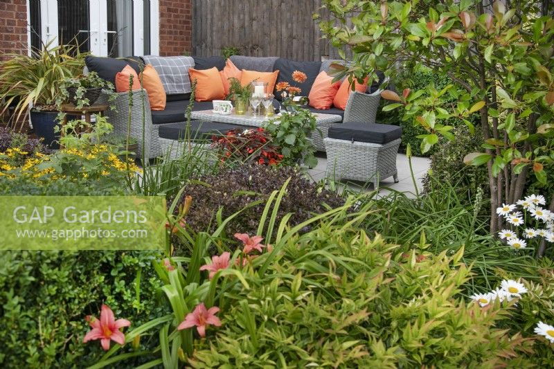 Seating and entertaining area in a small suburban garden in Lichfield, Staffordshire, July