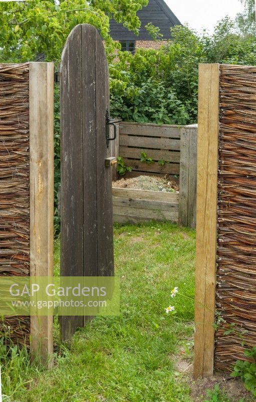 Screened off corner of garden to accomodate compost bays, wheelbarrows and other garden equipment - Open Gardens Day, Tuddenham, Suffolk