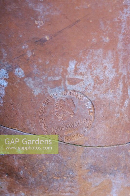 Details of vintage terracotta plant pot showing the makers mark.