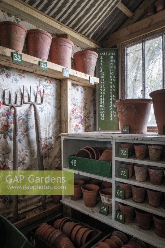 Inside of garden shed with collection of vintage terracotta plant pots organised by size