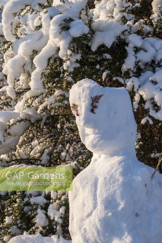 The garden at Gravetye Manor, Sussex, in winter. A snowman 
