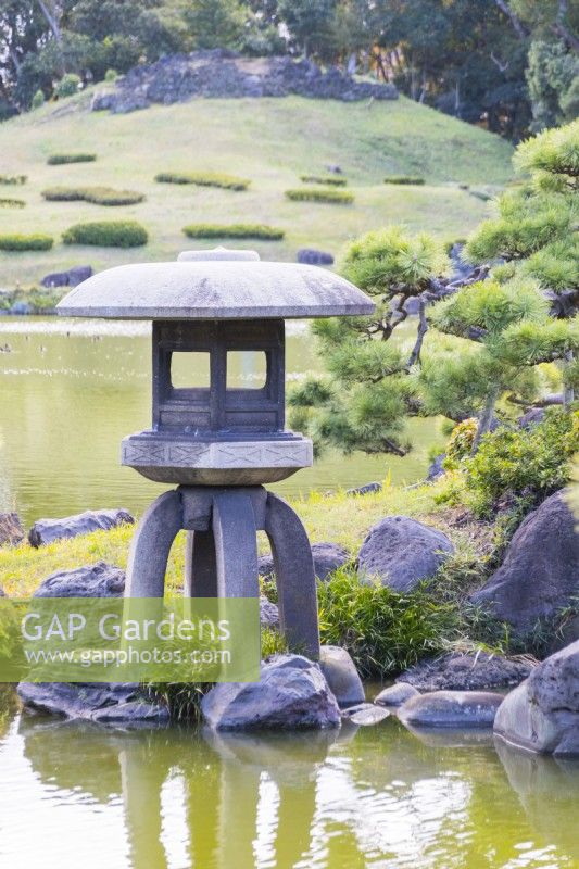 Four footed stone lantern at the edge of the lake