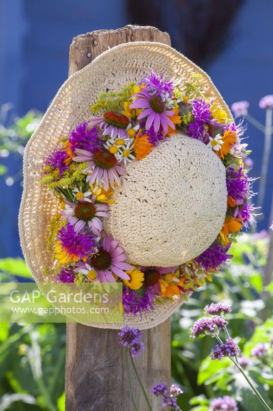 Hat with wreath made of pot marigold, coneflowers, chamomile, monarda and fennel.