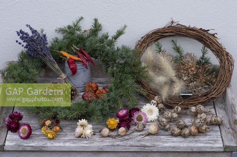 A Gardener's Garland wreath. You will need a woven frame 
covered in spruce foliage, with dried flowers, cones, wired seedheads and fruits to decorate.