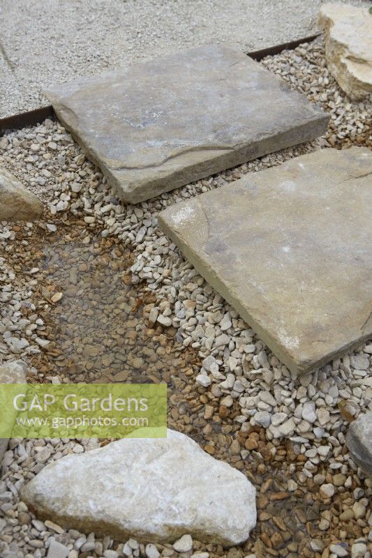 Stepping stone slabs laid on gravel for easy drainage.