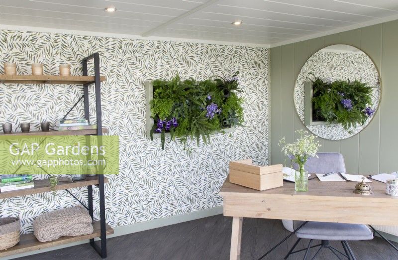 Working from home office Modern interior with a living wall feaure with planting of various ferns including Adiantum raddianum and Nephrolepis exaltata
