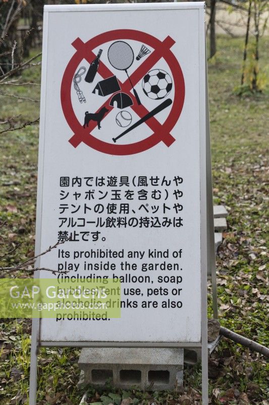 Sign in the garden in English and Japanese prohibiting several activities