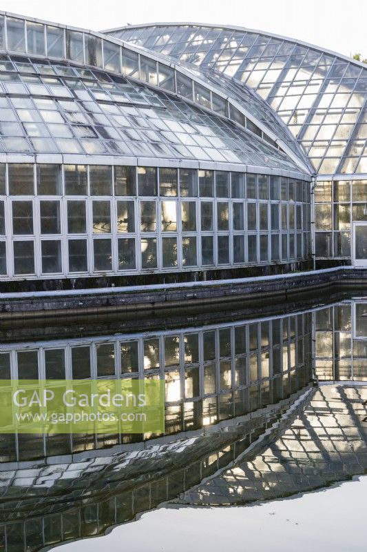 The Conservatory reflected in the adjacent pool. 