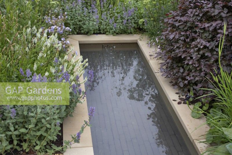 The rill surrounded by mixed perennials in 'The Wedgwood Garden' at RHS Chatsworth Flower Show 2019, June