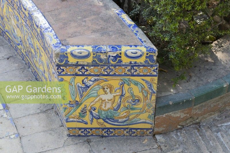 A colourful, Moorish style, tiled bench at the Real Alcazar Palace gardens, Seville. Spain. September. 