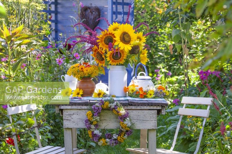 Summer bouquets with sunflowers on the table.