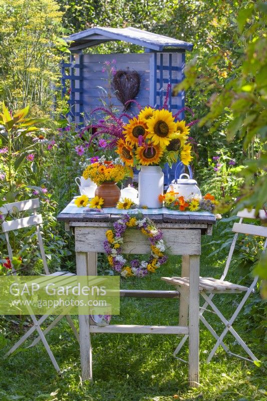 Summer bouquets with sunflowers on the table.