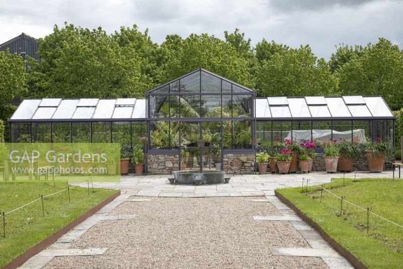 Glasshouse with display of potted plants at Yeo Valley Organic Garden, May