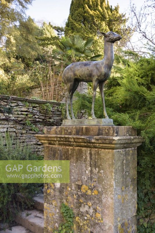 Bronze deer on a stone plinth at Iford Manor in January