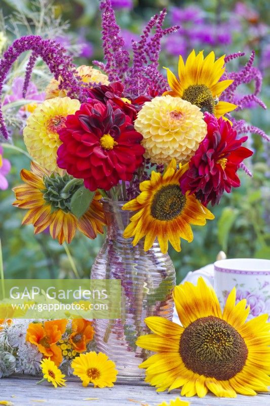Summer flower bouquet with hot colours including dahlias, sunflowers and Amaranthus caudatus.