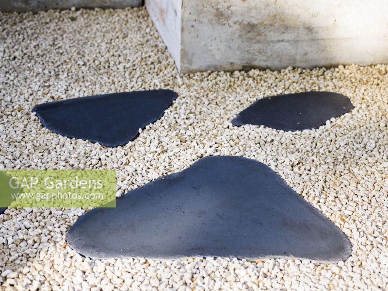 Detail of a path with irregular stepping stones.  The Shifting Garden, Designer: The Chelsea Gardener, RHS Chelsea Flower Show 2023