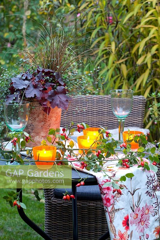 Table with lanterns in the autumn garden 
