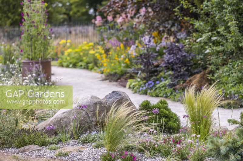 Stipa tenuissima in drought tolerant area. RHS Iconic Horticultural Hero Garden, Designer: Carol Klein, RHS Hampton Court Palace Garden Festival 2023