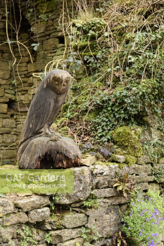 Carved owl in a ruined bulding at Cerney House Gardens in March