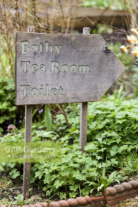 Wooden sign at Cerney House Gardens in March