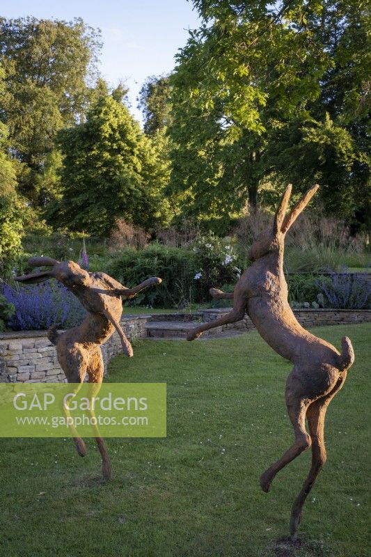 'Boxing Hares' statue by Miranda Michels at the garden of Daglinworth House, Gloucestershire