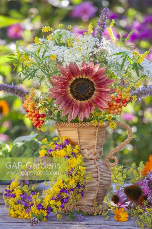Summer bouquet containing wildflowers and a sunflower.