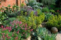 Suburban garden with raised dry border at Thursley Lodge in Surrey