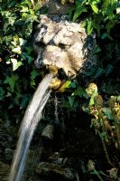 Lion's Head fountain spouting water at Munstead Wood in Surrey
