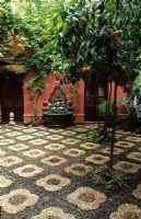 Patio with pebbles mosaics and orange trees in Cordoba patio festival in Spain
