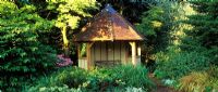 Summer house by pond at Foggy Bottom, Bressingham Gardens Norfolk