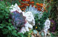 Ceramic sculptures in amongst planting at Roger Raiche's garden in Berkeley, California USA