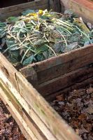 Wooden compost bins with general compost material and leaves for leaf mould 