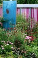'Looking at the world through rose tinted spectacles' Modern colourful screen amongst planting designed by Wendy Smith and Fern Alder.