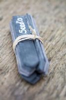 Bundle of slate garden markers tied with string