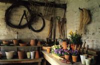 Potting shed with tools and pots at Thursley Lodge, Surrey
