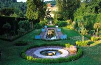 The Dower House, Shropshire. Formal water garden with rill and circular pool with view across garden to house