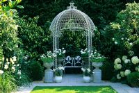 Decorative gazebo with seat at The Little Cottage